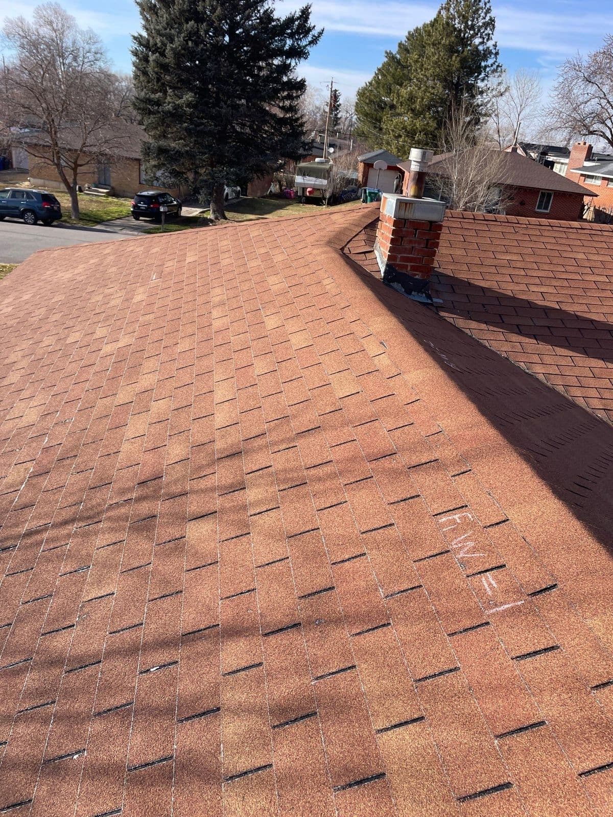 Old reddish-brown roof with chimney