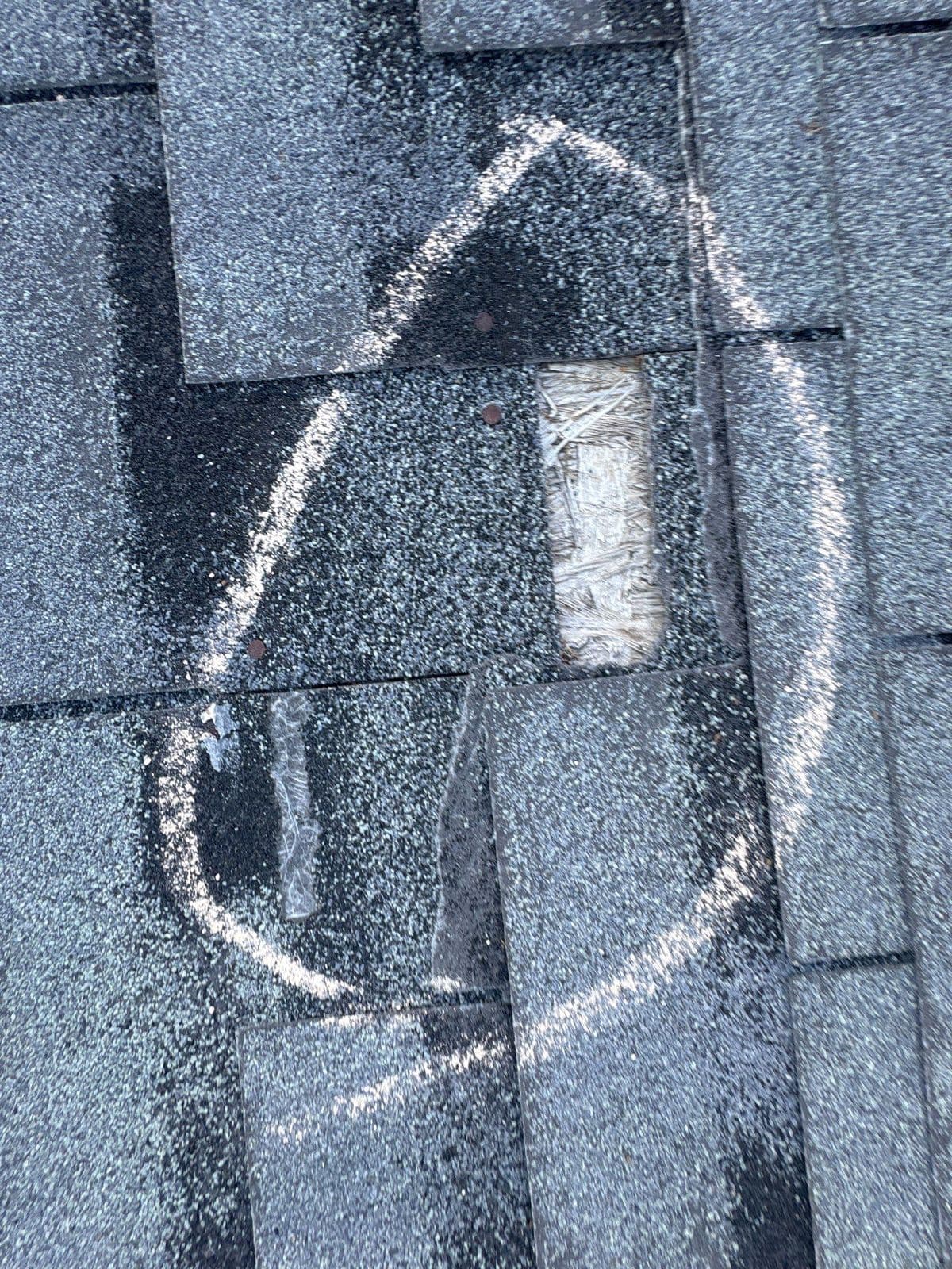 A missing shingle circled in chalk