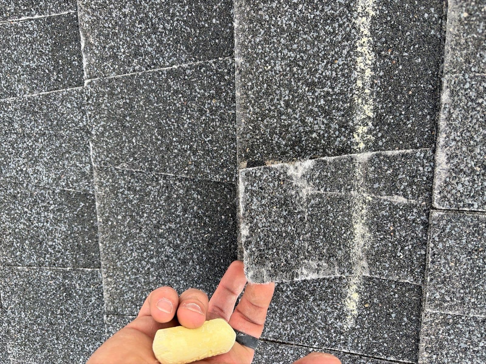 A creased shingle with chalk marks