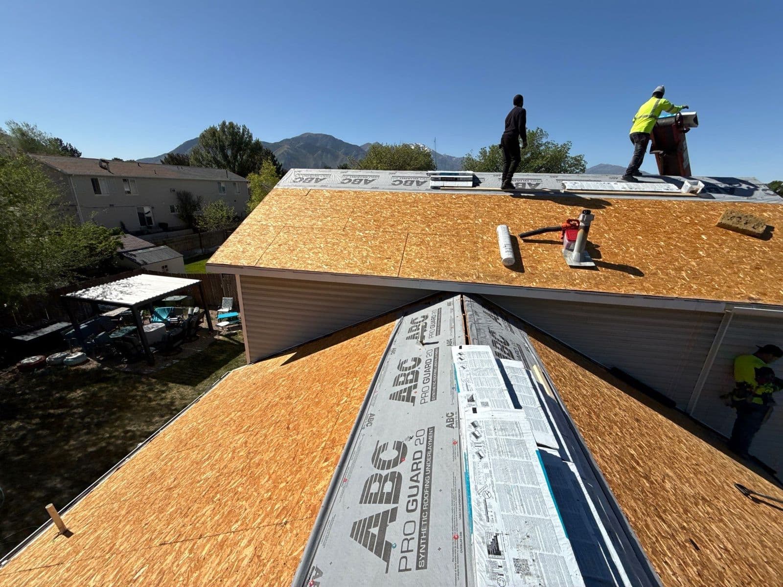Crew laying underlayment over new decking
